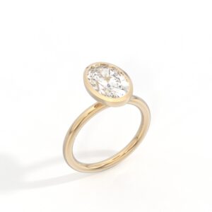Custom oval bezel-set solitaire engagement ring in yellow gold, designed in Greenville, South Carolina